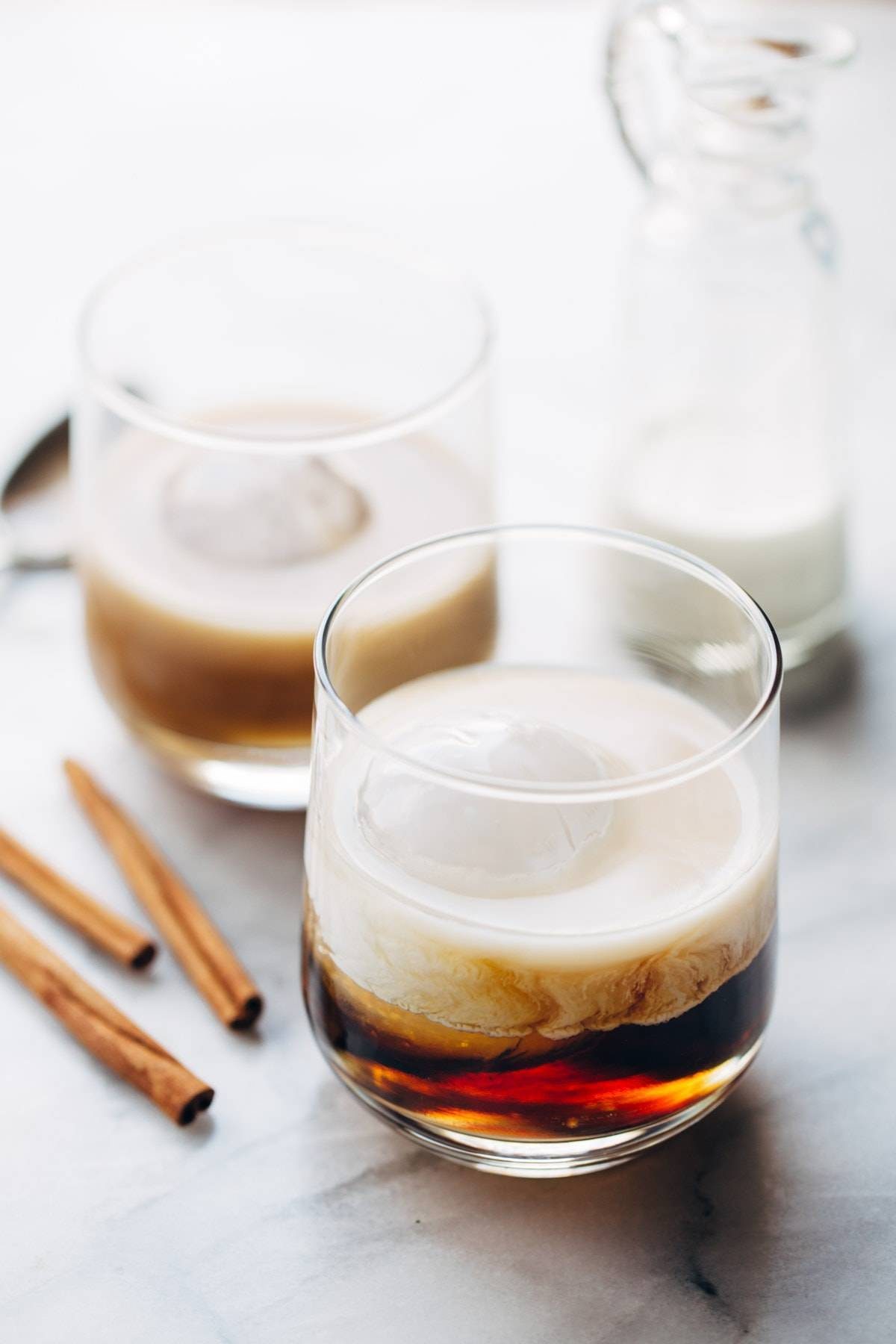 This Cinnamon White Russian is a perfect holiday party drink! with just four ingredients - vodka, coffee liquor, cinnamon simple syrup, and cream. | pinchofyum.com