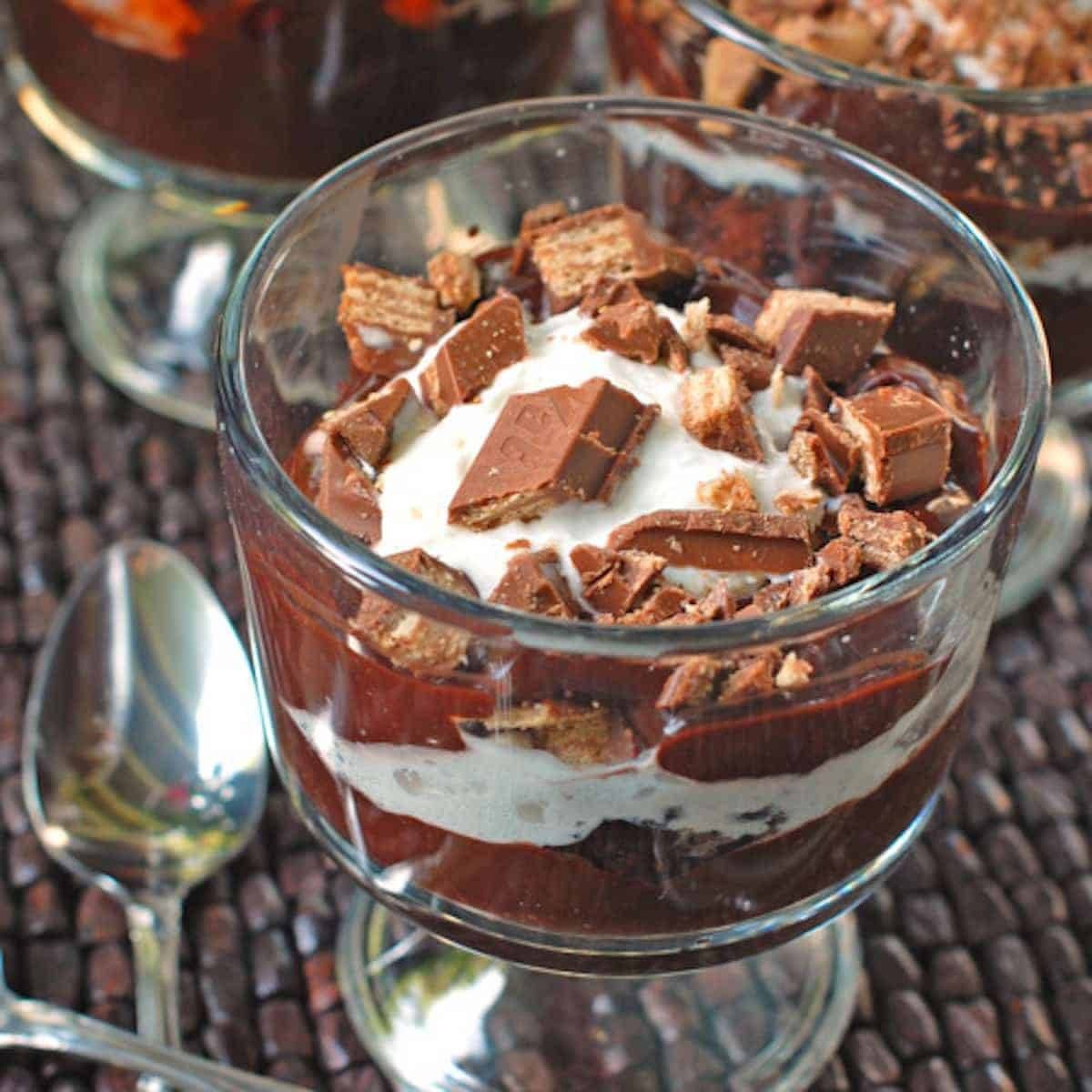 Brownie fudge trifle with layers of gooey brownie, chocolate pudding, chocolate fudge, and whipped cream. Chocolate lover's dream! | pinchofyum.com